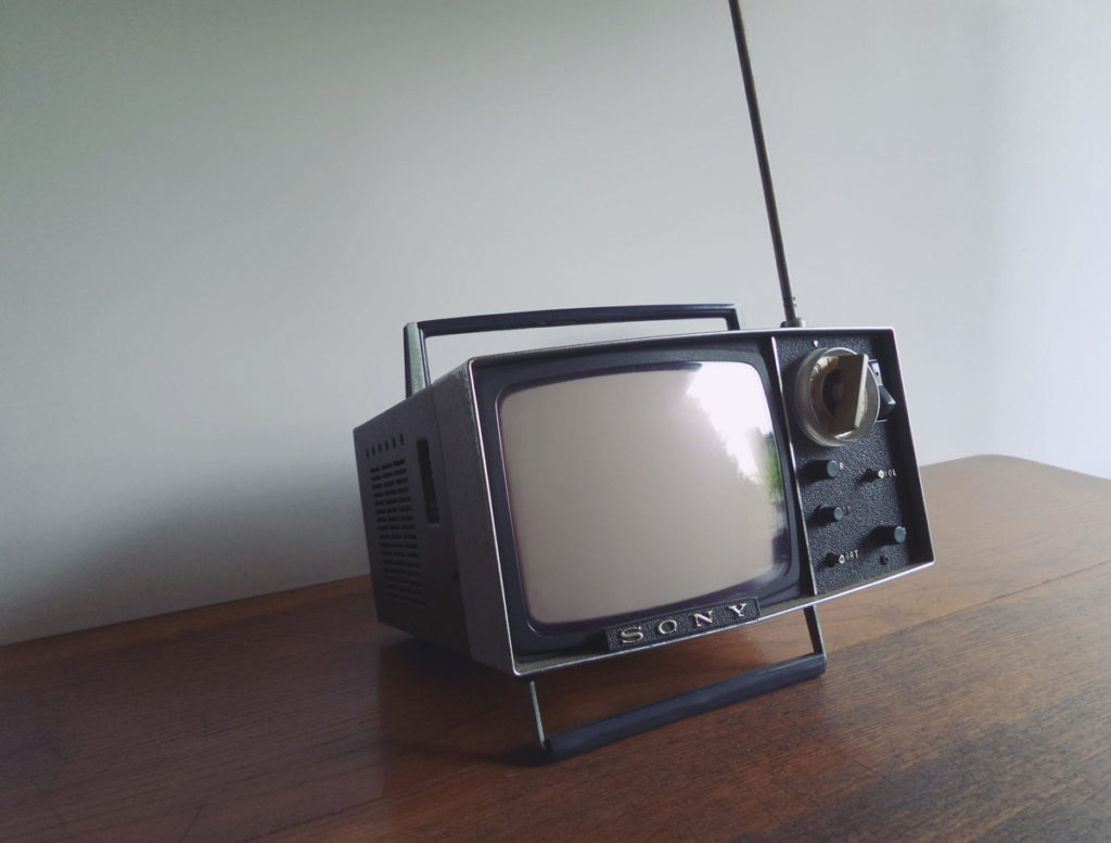 Image of old tv sitting on a wood table