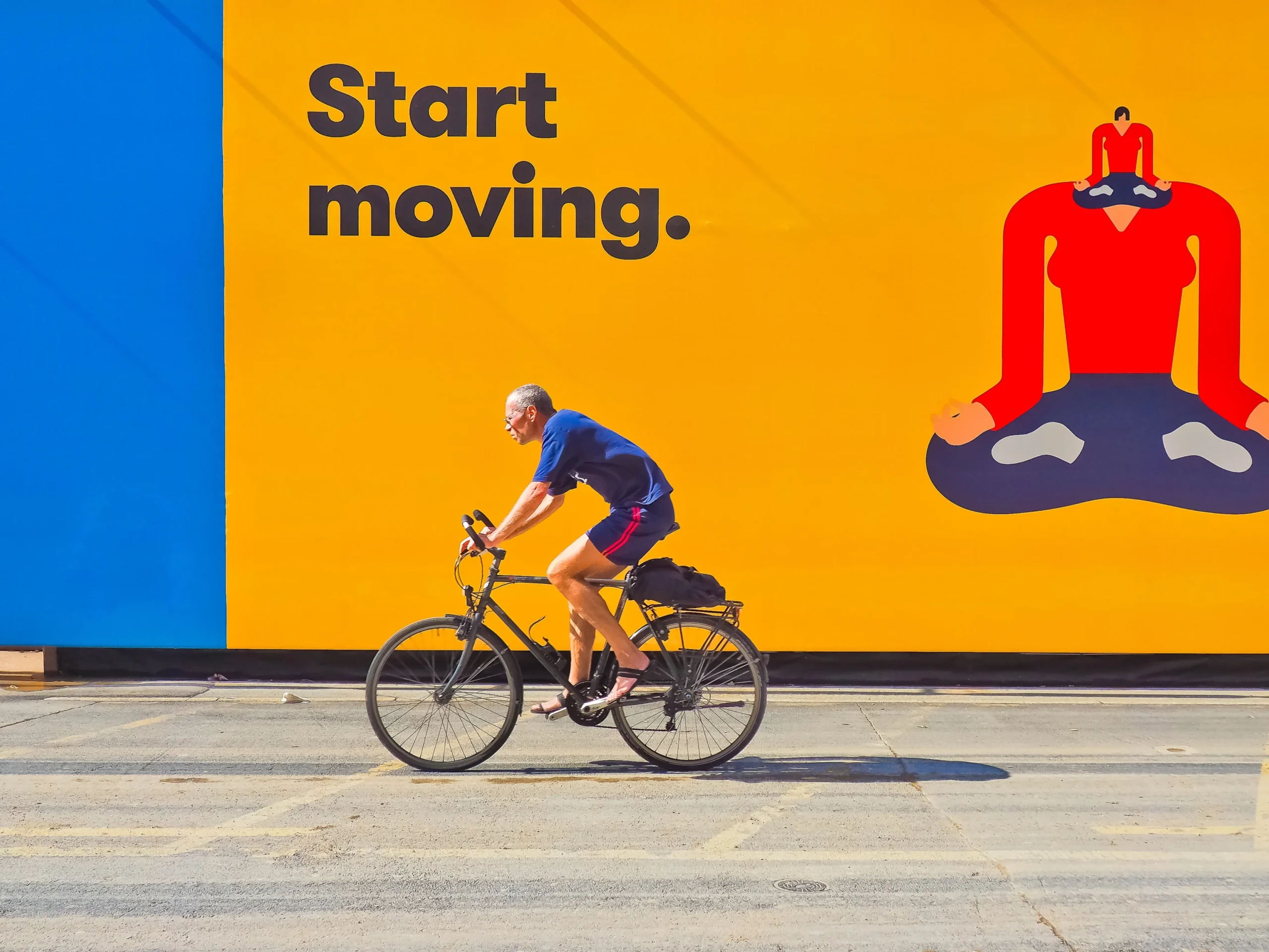 example of outdoor marketing showing where to use a logo - man riding bike in front of advertisement