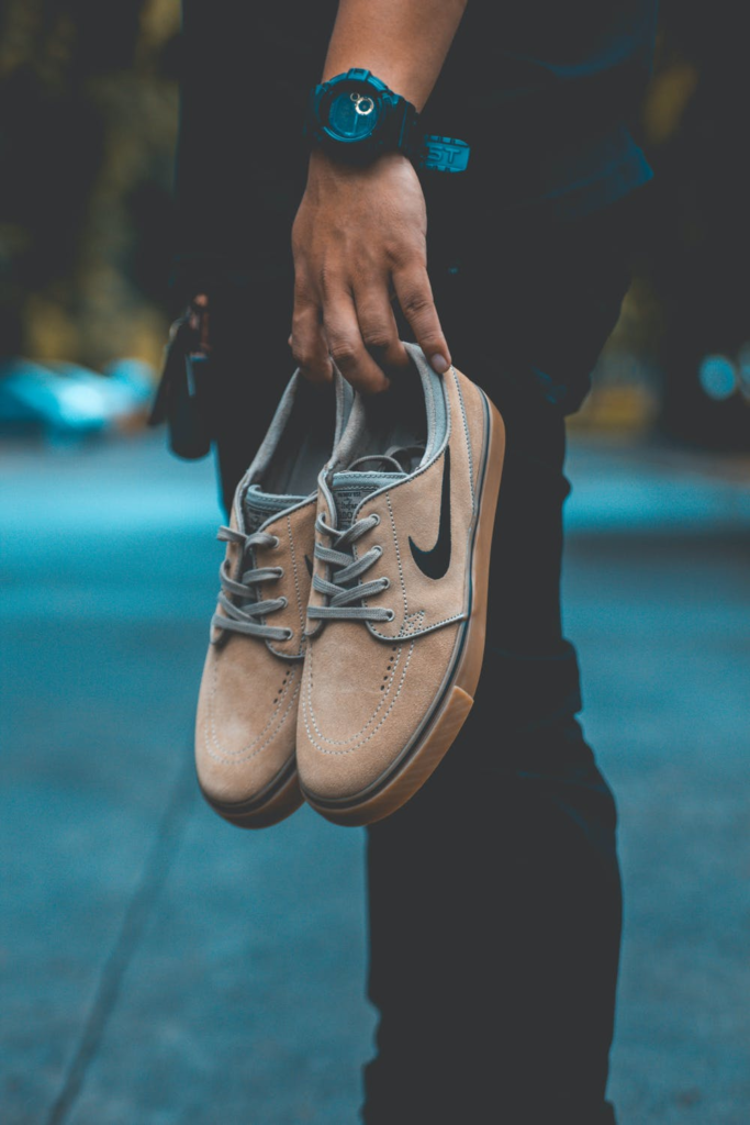 man holding branded shoes