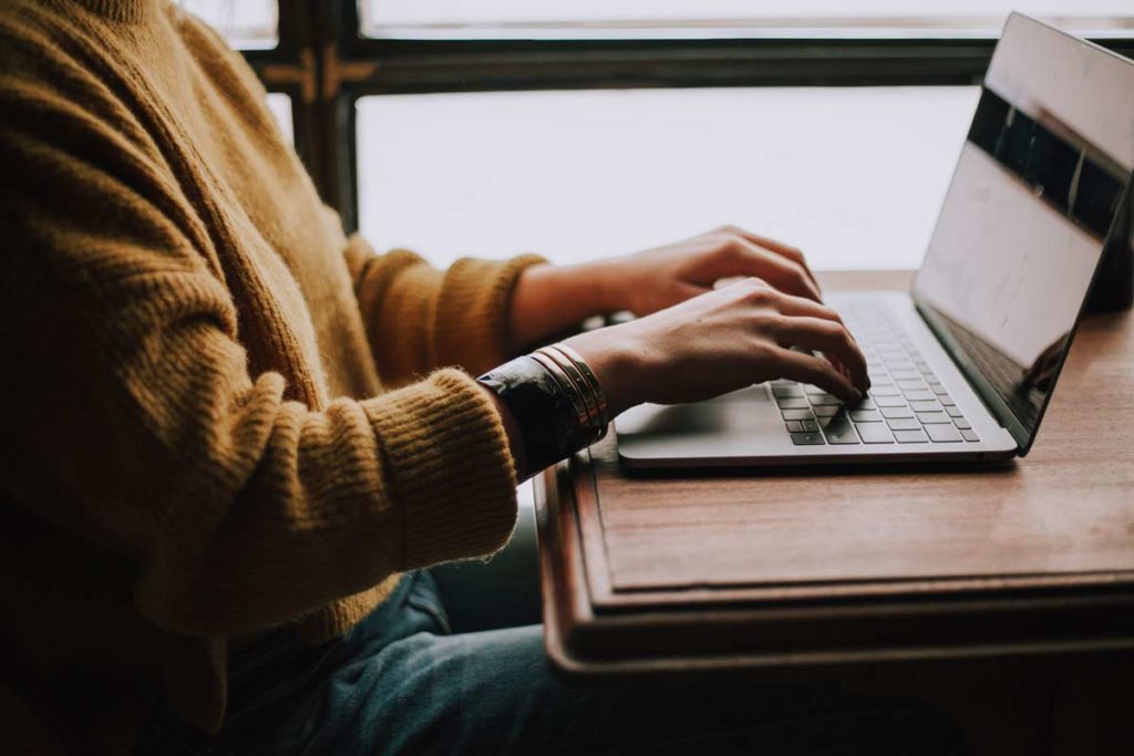 woman types on computer