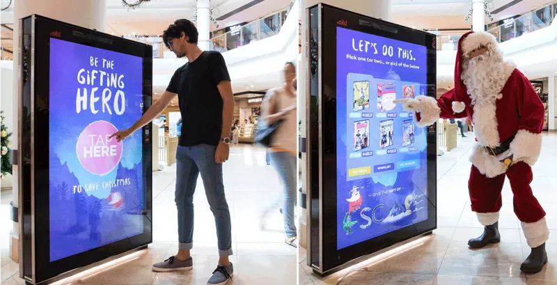 People interacting with a interactive billboard inside of a mall