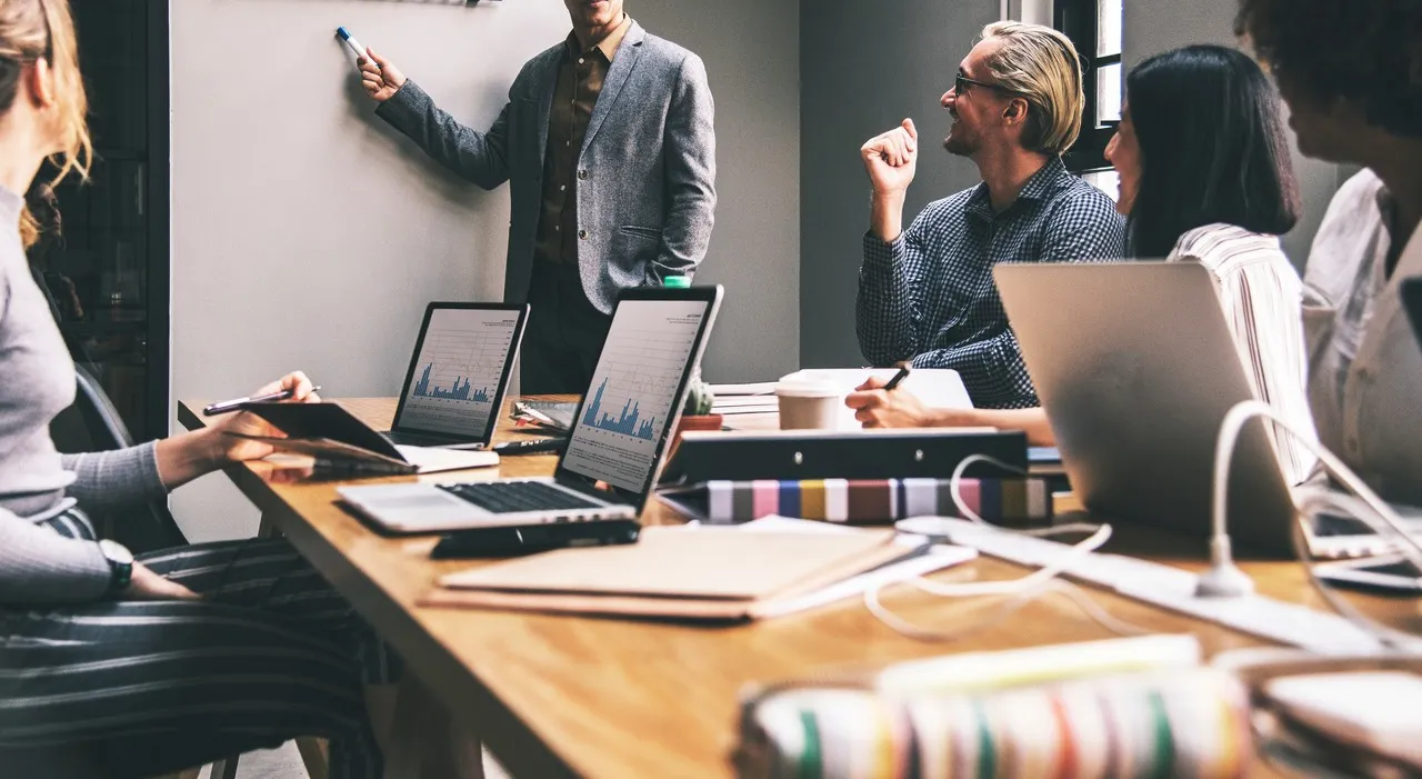 Members of a strategic media planning agency brainstorming together at a conference table