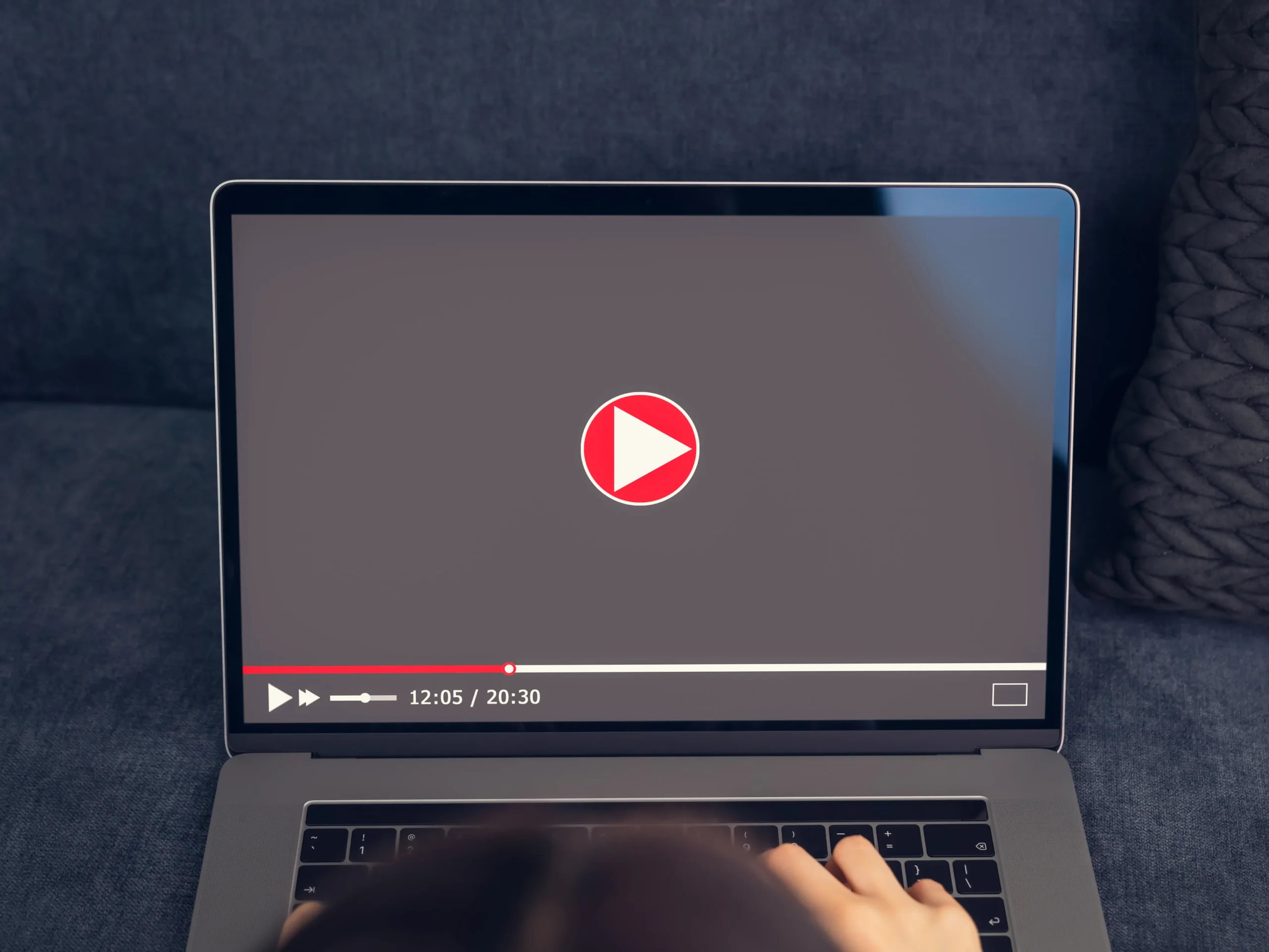 laptop with play button on computer screen to represent advertising on streaming services