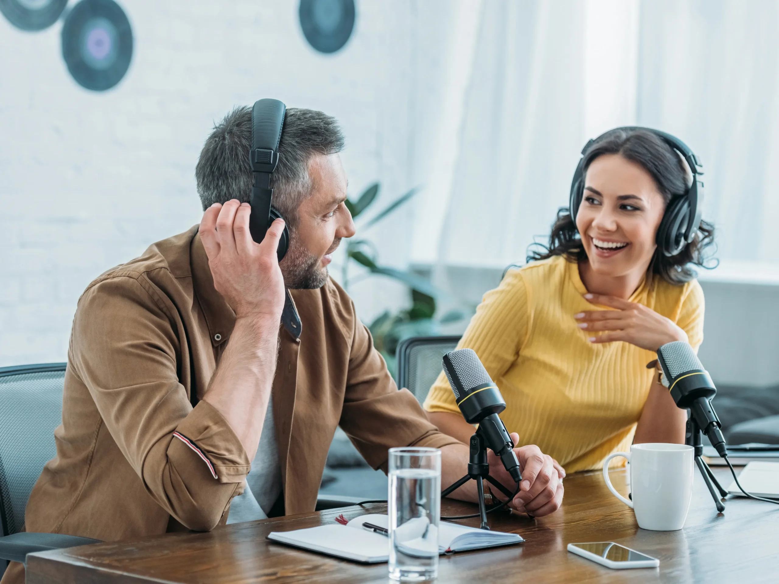 two people talking into mics - recording on the radio